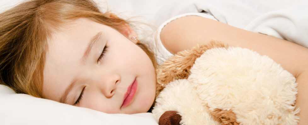 Adorable little girl sleeping in the bed